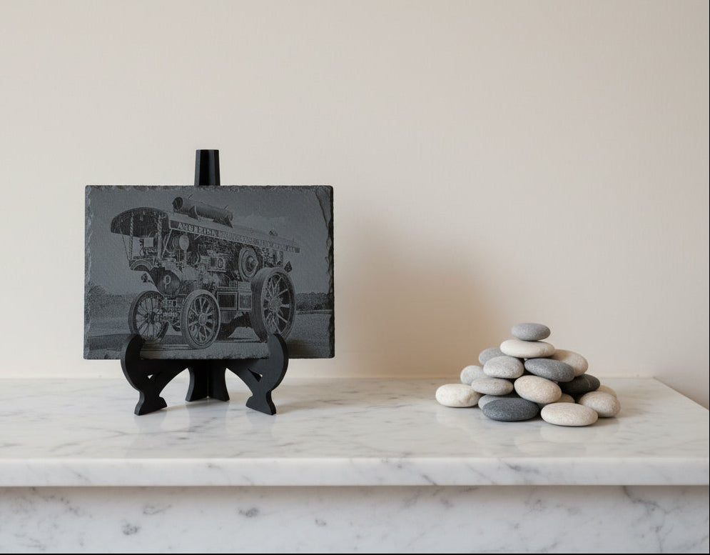 A striking laser-engraved slate featuring a detailed Traction engine design
