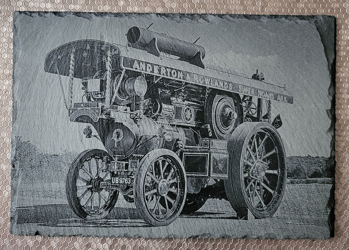 A striking laser-engraved slate featuring a detailed Traction engine design
