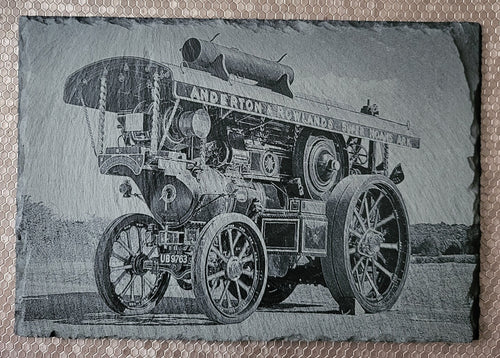 A striking laser-engraved slate featuring a detailed Traction engine design